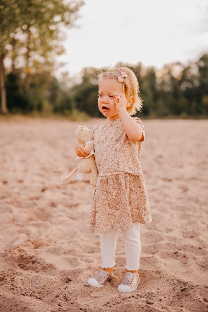 Children running and playing outdoors during a family photography session with motion frozen using a fast shutter speed.