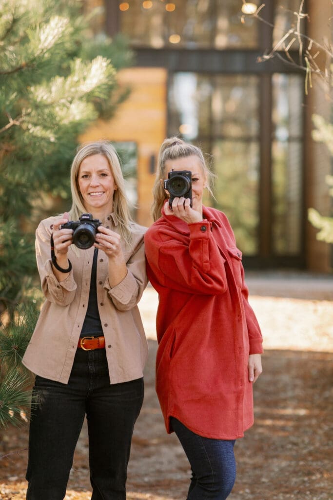 Portrait photographer adjusting camera settings while learning shutter speed for sharp, professional portraits.