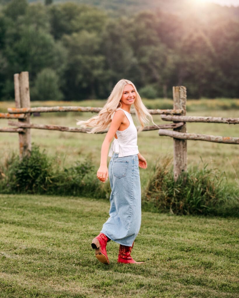 senior walking and spinning during an outdoor portrait session captured with a fast shutter speed.