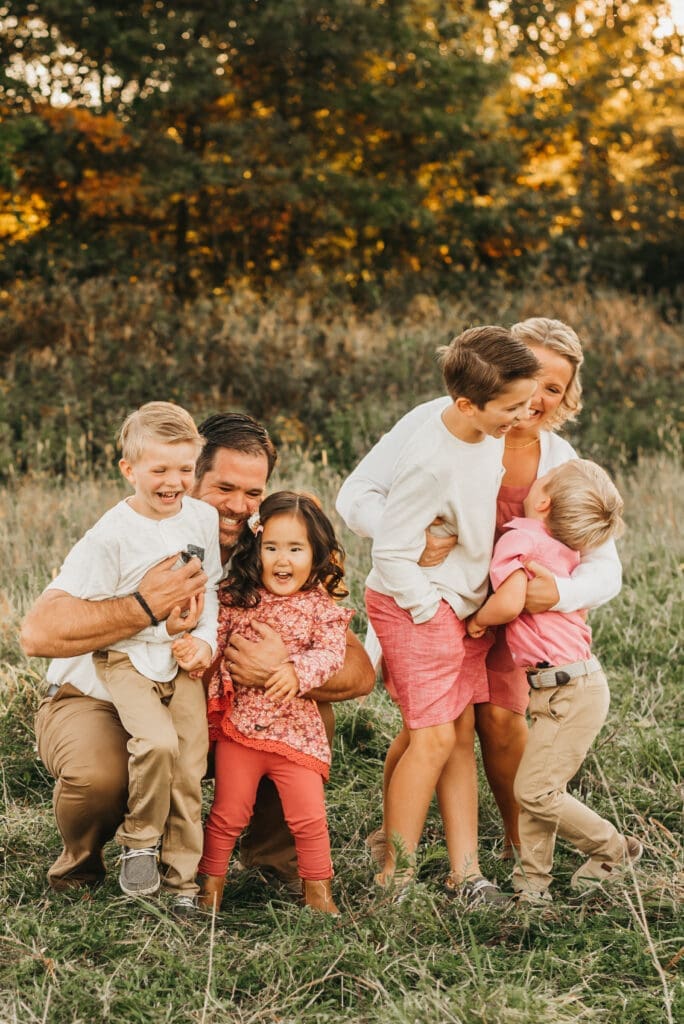 Family during an outdoor portrait session photographed with a fast shutter speed for sharp images.