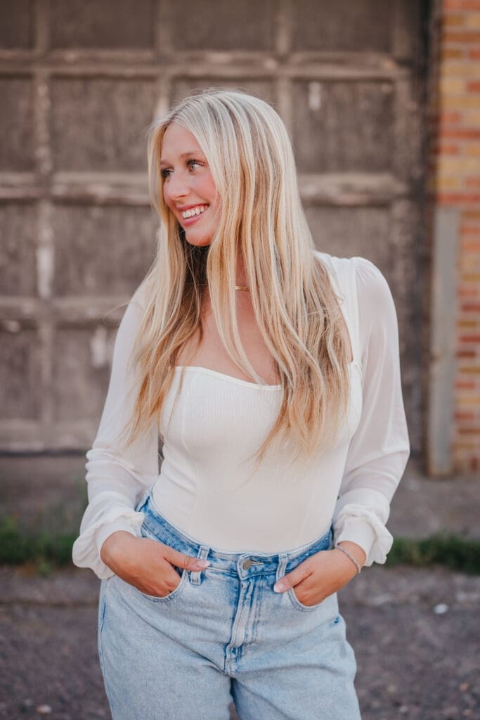 senior walking and spinning during an outdoor portrait session captured with a fast shutter speed.