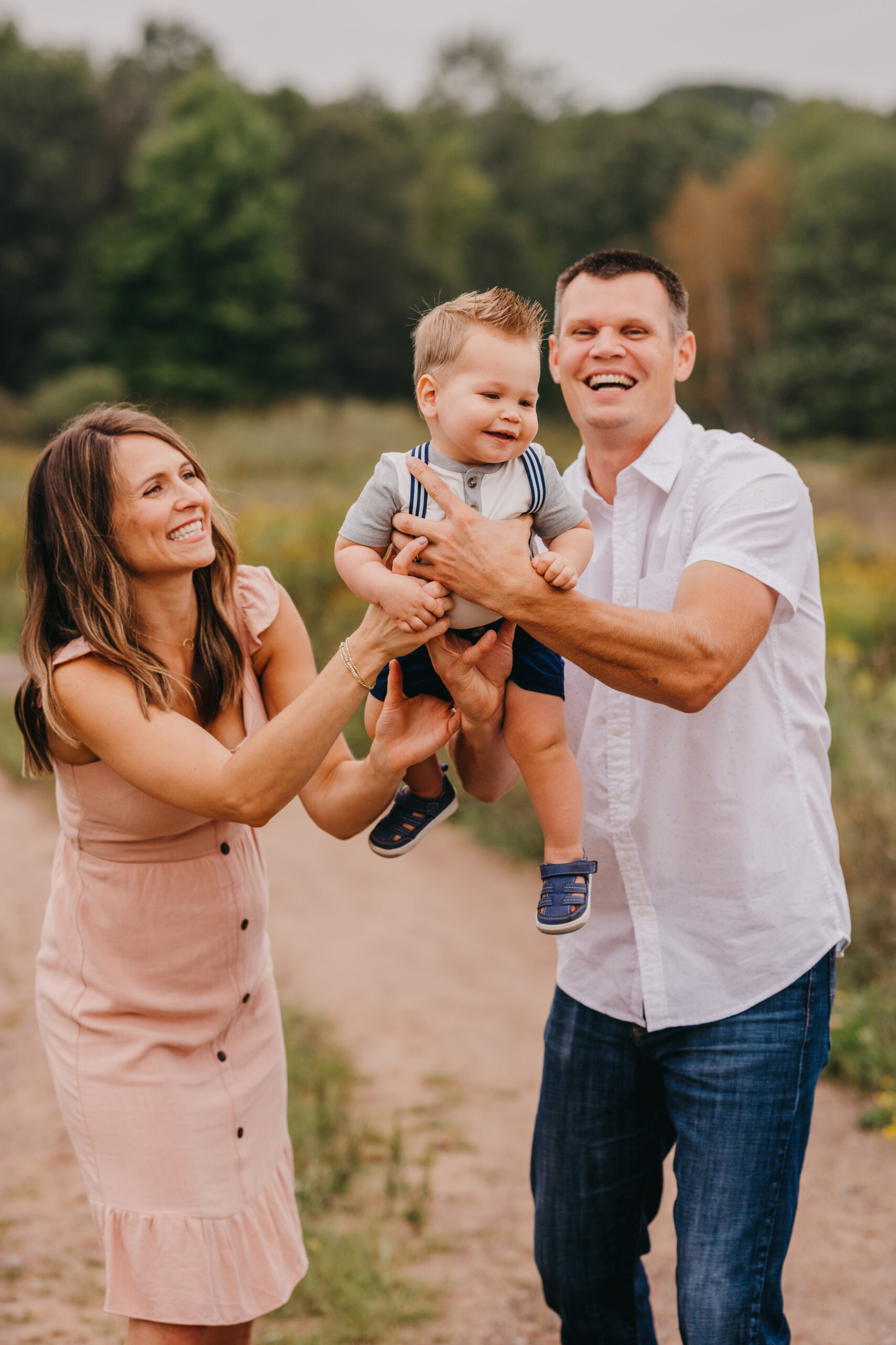 Photographer posing a young family during an outdoor session