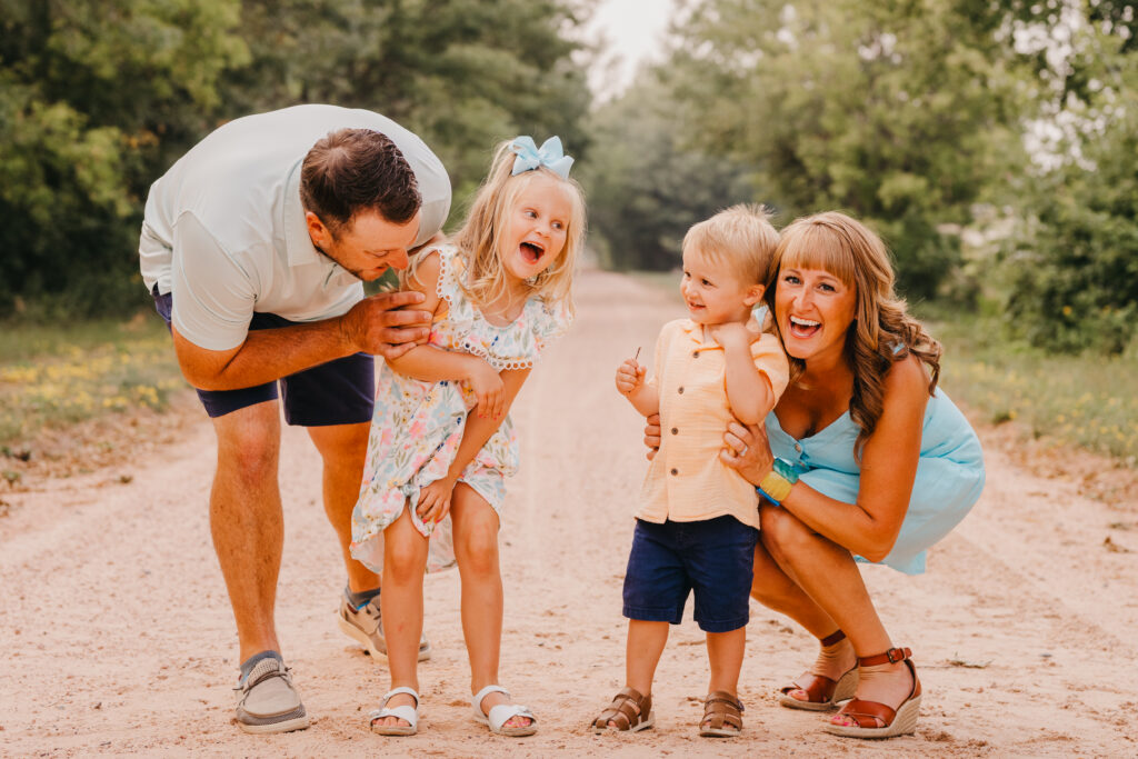 Photographer posing a young family during an outdoor session