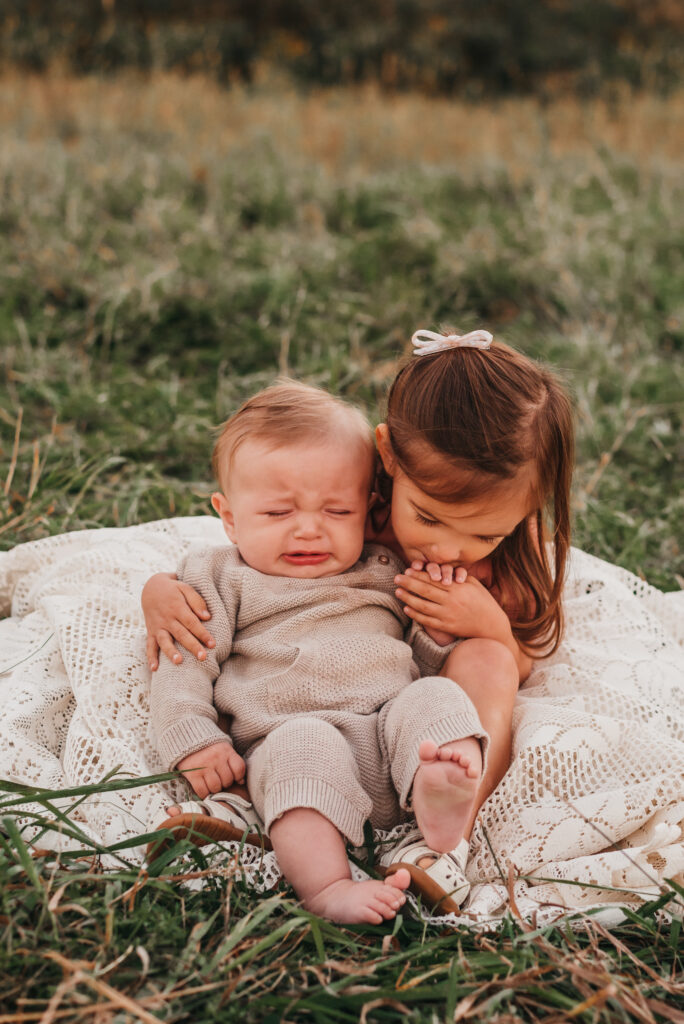 Photographer posing a young family during an outdoor session
