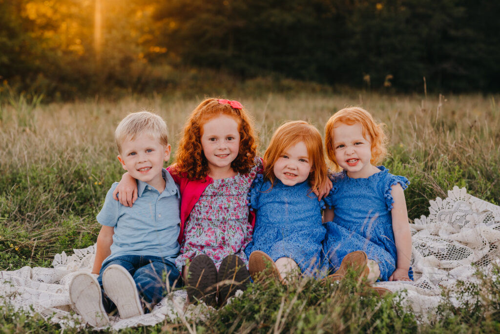 Photographer posing a young family during an outdoor session