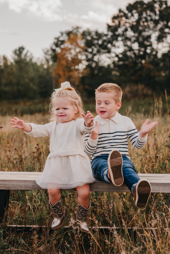 Photographer posing a young family during an outdoor session