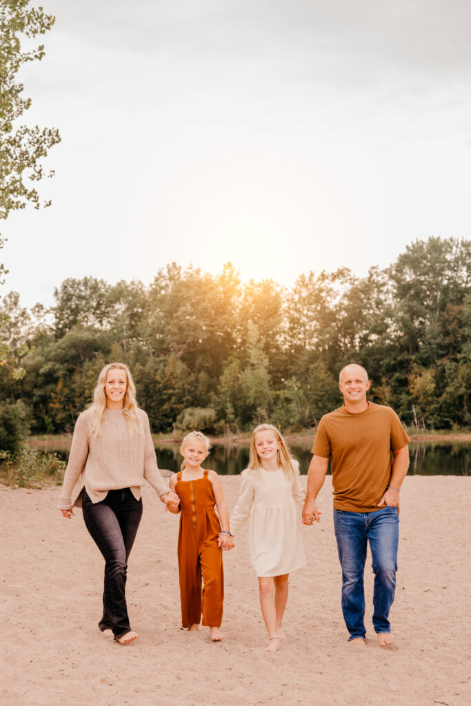 Photographer posing a young family during an outdoor session